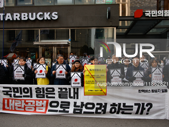 Around 30 members of the Korean Confederation of Trade Unions (KCTU) and other civil society groups hold a press conference in front of the...