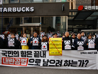 Around 30 members of the Korean Confederation of Trade Unions (KCTU) and other civil society groups hold a press conference in front of the...