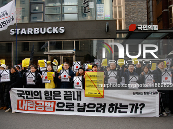 Around 30 members of the Korean Confederation of Trade Unions (KCTU) and other civil society groups hold a press conference in front of the...