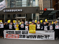 Around 30 members of the Korean Confederation of Trade Unions (KCTU) and other civil society groups hold a press conference in front of the...