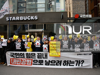 Around 30 members of the Korean Confederation of Trade Unions (KCTU) and other civil society groups hold a press conference in front of the...