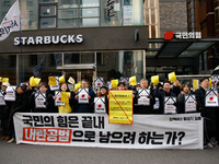 Around 30 members of the Korean Confederation of Trade Unions (KCTU) and other civil society groups hold a press conference in front of the...