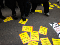 Members of the Korean Confederation of Trade Unions (KCTU) and other civil society groups attach a ''Notice of Eviction'' on the road in fro...