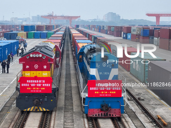 Two rail-sea freight trains leave Nanchang International Land Port Freight Yard in Nanchang, Jiangxi province, China, on December 12, 2024....