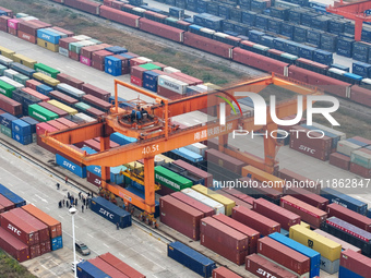 Cranes load import and export cargo containers at the Nanchang International Land Port Freight Yard cargo yard in Nanchang, Jiangxi province...