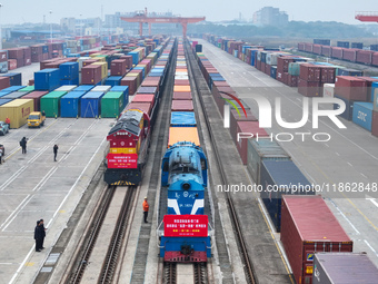 Two rail-sea freight trains leave Nanchang International Land Port Freight Yard in Nanchang, Jiangxi province, China, on December 12, 2024....