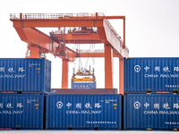 Cranes load import and export cargo containers at the Nanchang International Land Port Freight Yard cargo yard in Nanchang, Jiangxi province...