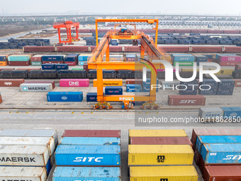 Cranes load import and export cargo containers at the Nanchang International Land Port Freight Yard cargo yard in Nanchang, Jiangxi province...