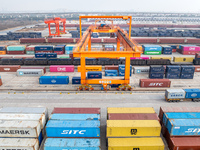 Cranes load import and export cargo containers at the Nanchang International Land Port Freight Yard cargo yard in Nanchang, Jiangxi province...