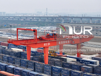 Cranes load import and export cargo containers at the Nanchang International Land Port Freight Yard cargo yard in Nanchang, Jiangxi province...