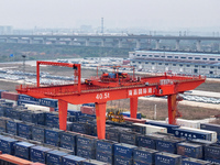 Cranes load import and export cargo containers at the Nanchang International Land Port Freight Yard cargo yard in Nanchang, Jiangxi province...