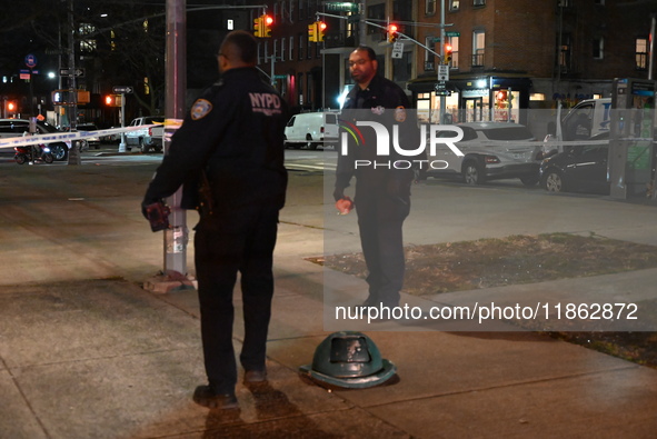 The NYPD evidence collection team gathers evidence and marks shell casings at the scene where two people are shot at Lafayette Gardens NYCHA...