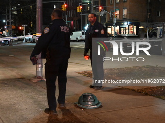 The NYPD evidence collection team gathers evidence and marks shell casings at the scene where two people are shot at Lafayette Gardens NYCHA...