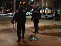 The NYPD evidence collection team gathers evidence and marks shell casings at the scene where two people are shot at Lafayette Gardens NYCHA...