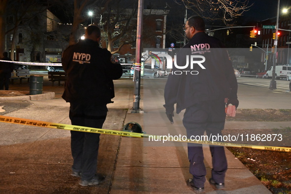 The NYPD evidence collection team gathers evidence and marks shell casings at the scene where two people are shot at Lafayette Gardens NYCHA...