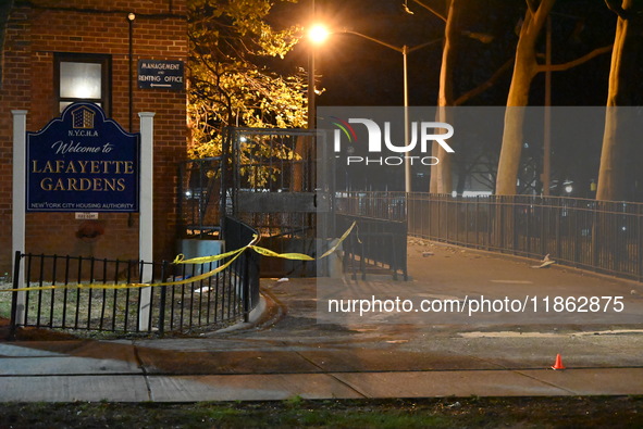 The NYPD evidence collection team gathers evidence and marks shell casings at the scene where two people are shot at Lafayette Gardens NYCHA...