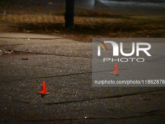 The NYPD evidence collection team gathers evidence and marks shell casings at the scene where two people are shot at Lafayette Gardens NYCHA...