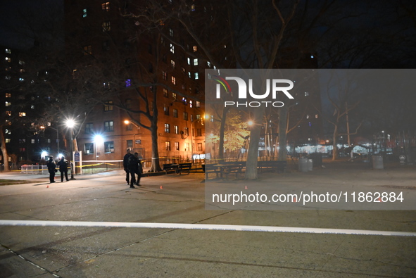 The NYPD evidence collection team gathers evidence and marks shell casings at the scene where two people are shot at Lafayette Gardens NYCHA...