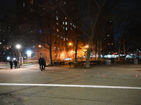 The NYPD evidence collection team gathers evidence and marks shell casings at the scene where two people are shot at Lafayette Gardens NYCHA...