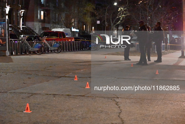 The NYPD evidence collection team gathers evidence and marks shell casings at the scene where two people are shot at Lafayette Gardens NYCHA...