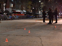 The NYPD evidence collection team gathers evidence and marks shell casings at the scene where two people are shot at Lafayette Gardens NYCHA...