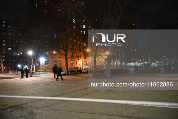 The NYPD evidence collection team gathers evidence and marks shell casings at the scene where two people are shot at Lafayette Gardens NYCHA...