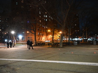 The NYPD evidence collection team gathers evidence and marks shell casings at the scene where two people are shot at Lafayette Gardens NYCHA...