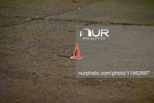 The NYPD evidence collection team gathers evidence and marks shell casings at the scene where two people are shot at Lafayette Gardens NYCHA...