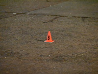 The NYPD evidence collection team gathers evidence and marks shell casings at the scene where two people are shot at Lafayette Gardens NYCHA...