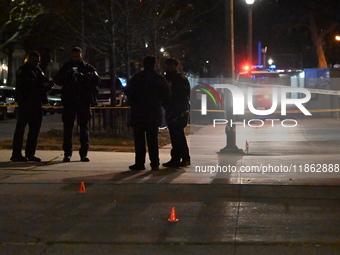 The NYPD evidence collection team gathers evidence and marks shell casings at the scene where two people are shot at Lafayette Gardens NYCHA...