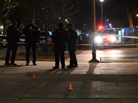 The NYPD evidence collection team gathers evidence and marks shell casings at the scene where two people are shot at Lafayette Gardens NYCHA...