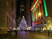 The Christmas tree on Broad Street and colored seasonal lights illuminate the New York Stock Exchange in New York, N.Y., on December 12, 202...