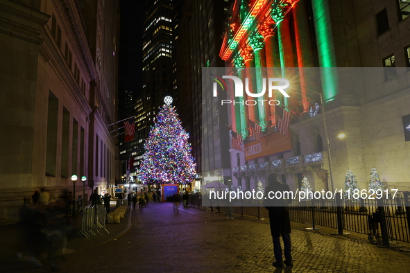 The Christmas tree on Broad Street and colored seasonal lights illuminate the New York Stock Exchange in New York, N.Y., on December 12, 202...