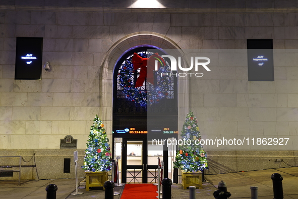 Christmas decorations are on Broad Street outside the New York Stock Exchange in New York, N.Y., on December 12, 2024. The photo is taken as...