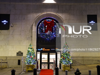 Christmas decorations are on Broad Street outside the New York Stock Exchange in New York, N.Y., on December 12, 2024. The photo is taken as...