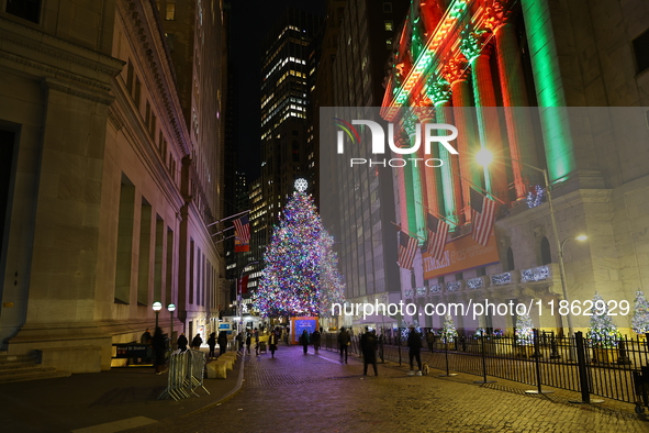 The Christmas tree on Broad Street and colored seasonal lights illuminate the New York Stock Exchange in New York, N.Y., on December 12, 202...