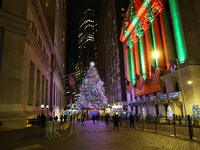 The Christmas tree on Broad Street and colored seasonal lights illuminate the New York Stock Exchange in New York, N.Y., on December 12, 202...