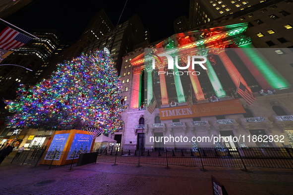 The Christmas tree on Broad Street and colored seasonal lights illuminate the New York Stock Exchange in New York, N.Y., on December 12, 202...