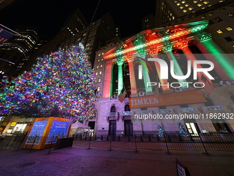 The Christmas tree on Broad Street and colored seasonal lights illuminate the New York Stock Exchange in New York, N.Y., on December 12, 202...