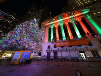 The Christmas tree on Broad Street and colored seasonal lights illuminate the New York Stock Exchange in New York, N.Y., on December 12, 202...