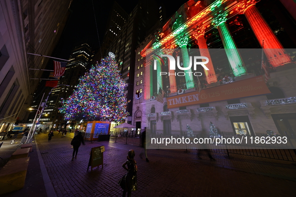 The Christmas tree on Broad Street and colored seasonal lights illuminate the New York Stock Exchange in New York, N.Y., on December 12, 202...