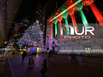 The Christmas tree on Broad Street and colored seasonal lights illuminate the New York Stock Exchange in New York, N.Y., on December 12, 202...