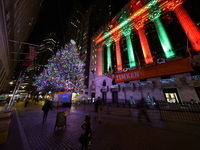 The Christmas tree on Broad Street and colored seasonal lights illuminate the New York Stock Exchange in New York, N.Y., on December 12, 202...