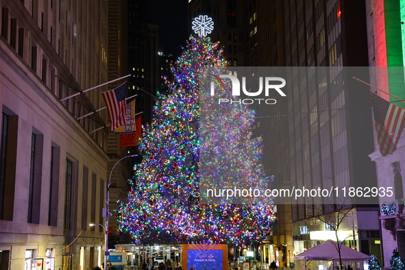 The Christmas tree on Broad Street and colored seasonal lights illuminate the New York Stock Exchange in New York, N.Y., on December 12, 202...