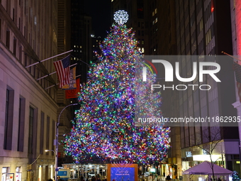 The Christmas tree on Broad Street and colored seasonal lights illuminate the New York Stock Exchange in New York, N.Y., on December 12, 202...