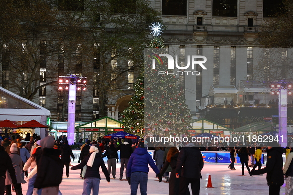 People skate in the Winter Village in Bryant Park in New York, N.Y., on December 12, 2024. The photo is taken as a long exposure. 