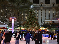 People skate in the Winter Village in Bryant Park in New York, N.Y., on December 12, 2024. The photo is taken as a long exposure. (