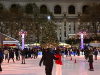 People skate in the Winter Village in Bryant Park in New York, N.Y., on December 12, 2024. The photo is taken as a long exposure. (