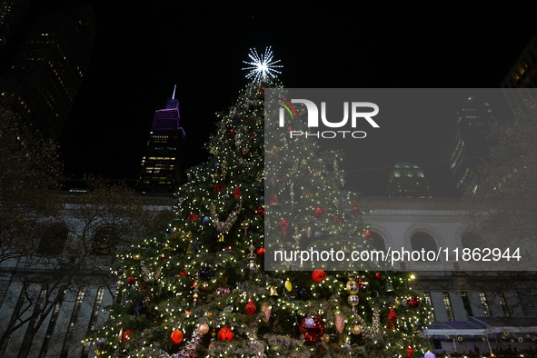 A Christmas tree stands in the Winter Village in Bryant Park in the heart of New York, N.Y., on December 12, 2024. The photo is taken as a l...