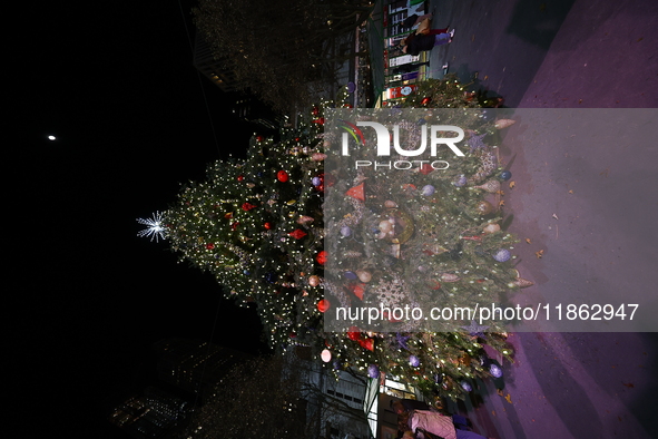 A Christmas tree stands in the Winter Village in Bryant Park in the heart of New York, N.Y., on December 12, 2024. The photo is taken as a l...